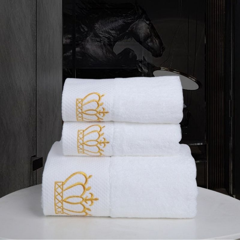 White hotel towel set with gold crown embroidery